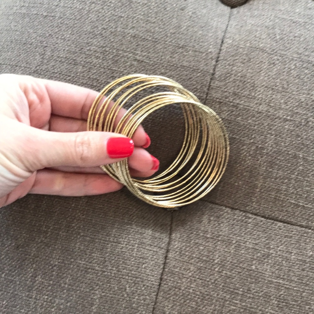 Stack of gold tone dainty bangles